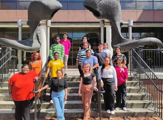 A group of students standing on the stairs in front of VCU's ram horns.