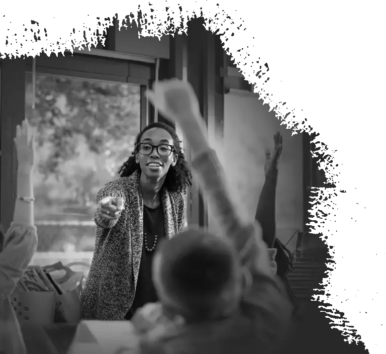 A person giving a lecture to a group of students whom appears to be motioning towards a display that's out of frame